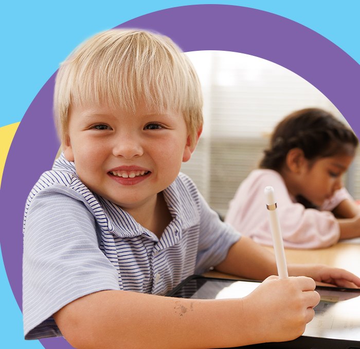 A happy young student smiling while working at Kumon of Wappingers Falls